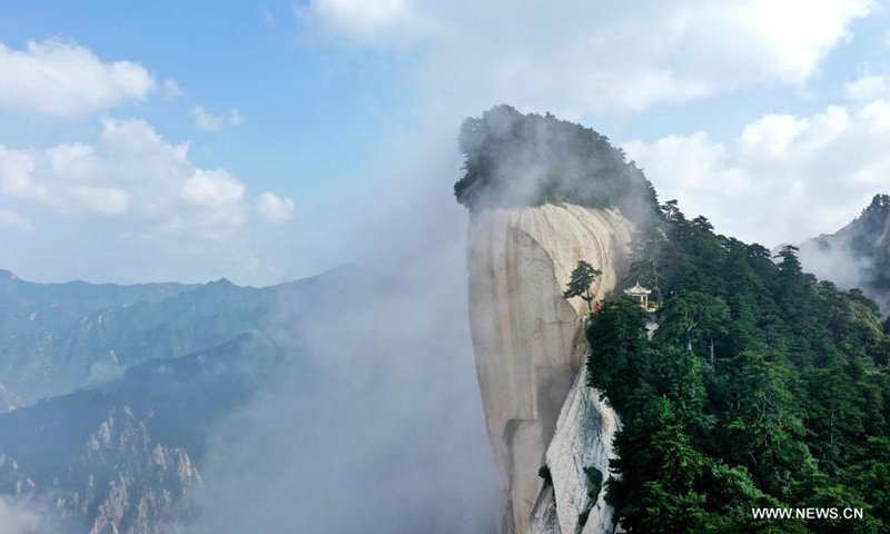 Aerial photo taken on Aug. 14, 2021 shows the mist-shrouded Mount Huashan in Weinan City, northwest China's Shaanxi Province. (Xinhua/Tao Ming)