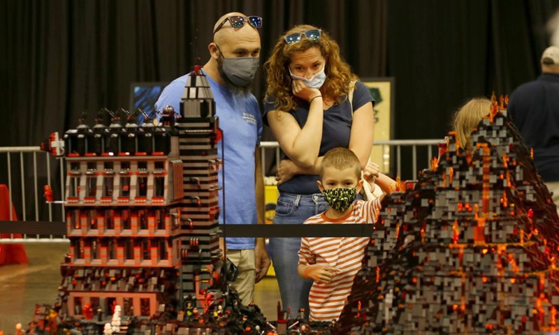 LEGO lovers observe a LEGO art piece during BrickUniverse Lego Fan Festival in Kenner, Louisiana, the United States, on Aug. 14, 2021. BrickUniverse Lego Fan Festival showcased hundreds of LEGO creations from global LEGO artists. (Photo by Lan Wei/Xinhua)

