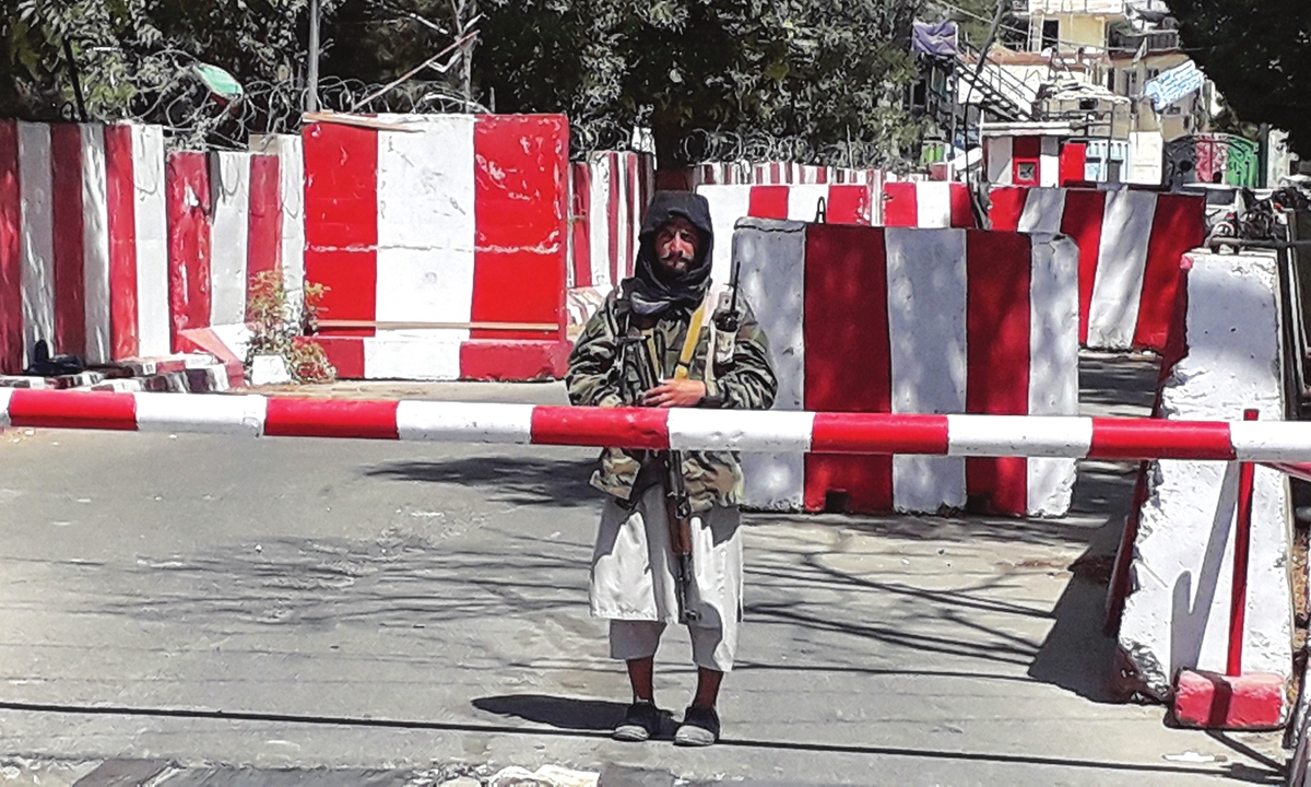 A Taliban fighter guards the entrance of the police headquarters in Ghazni, Afghan on Thursday, as the Taliban move closer to Kabul, the Afghan capital, after taking Ghazni (See story on Page 15). Photo: AFP