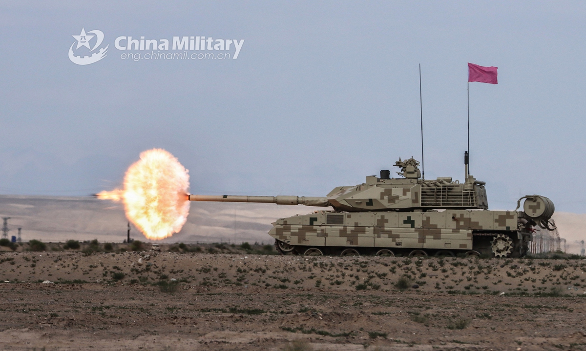 A main battle tank attached to a combined arms regiment under the PLA Nanjiang Military Command spits fires in a military shooting range in China’s Xinjiang Uyghur Autonomous Region on July 26, 2021. (eng.chinamil.com.cn/Photo by Tang Yayun)