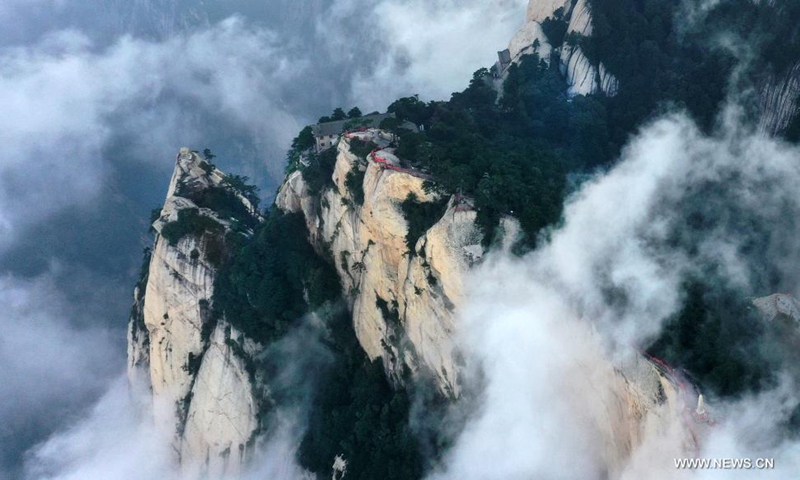 Aerial photo taken on Aug. 14, 2021 shows the mist-shrouded Mount Huashan in Weinan City, northwest China's Shaanxi Province. (Xinhua/Tao Ming)