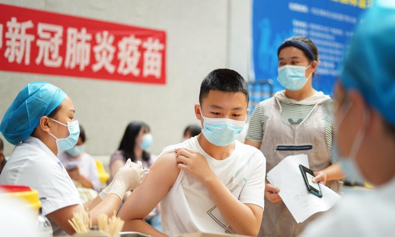A student receives a dose of COVID-19 vaccine at a vaccination point in Danzhai County, southwest China's Guizhou Province, Aug. 12, 2021.Photo:Xinhua