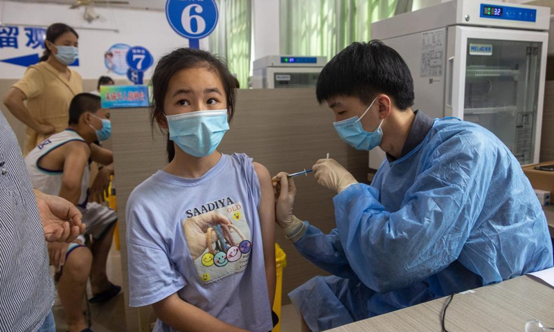 A student receives a dose of COVID-19 vaccine at a vaccination point in Danzhai County, southwest China's Guizhou Province, Aug. 12, 2021. China is orderly propelling its vaccination program among minors aged between 12 and 17, on the premise of ensuring safety.Photo:Xinhua