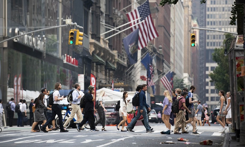 People walk on a street in New York, the United States, July 20, 2021.Photo:Xinhua