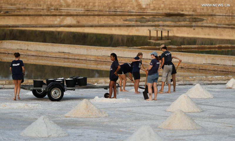People harvest salt in a salt pan in Salina, Malta, on Aug. 12, 2021.Photo:Xinhua