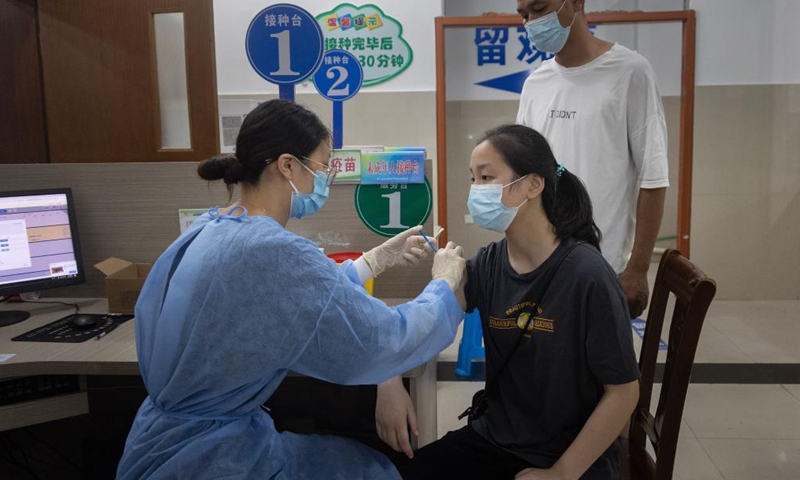 A girl receives a dose of COVID-19 vaccine at a vaccination point in Jingning She Autonomous County in Lishui, east China's Zhejiang Province, Aug. 12, 2021. China is orderly propelling its vaccination program among minors aged between 12 and 17, on the premise of ensuring safety.Photo:Xinhua