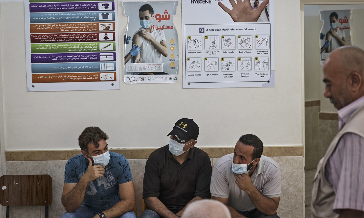Palestinians wait to receive a dose of the Sputnik V COVID-19 vaccine during an inoculation campaign at a medical center in Gaza City on Sunday. Photo: AFP