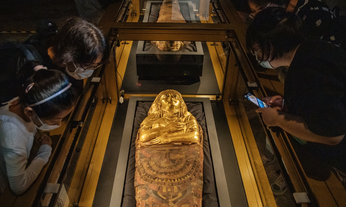 Visitors explore the <em>Golden Mummies of Egypt</em> exhibition at the World Art Museum in Beijing on Sunday. Photo: Li Hao/GT