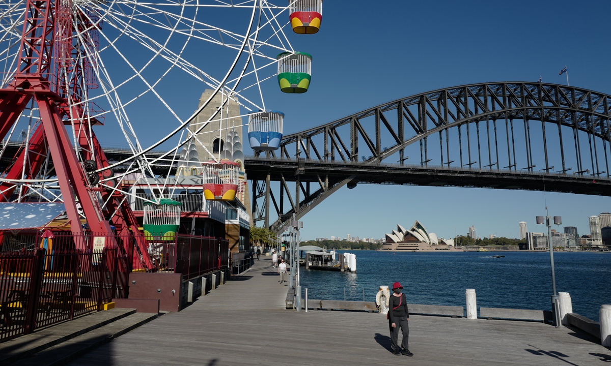 People exercises beside Luna Park on Monday in Sydney, Australia. COVID-19 restrictions have been tightened across New South Wales as positive COVID-19 case numbers continue to rise. Photo: VCG