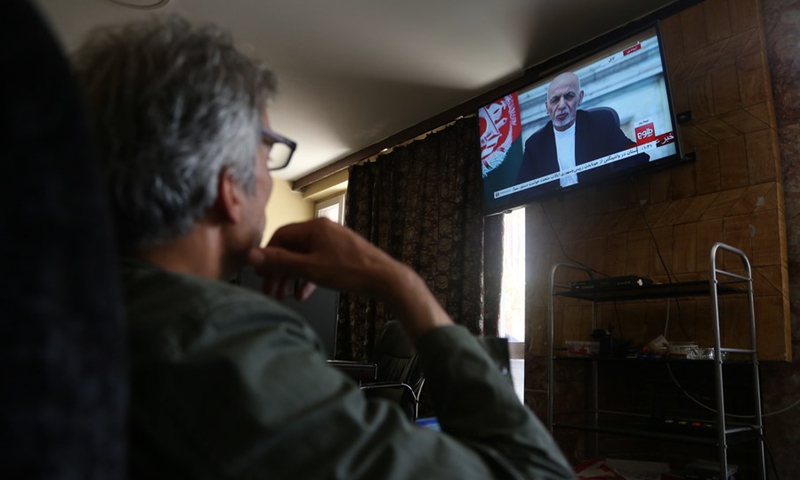 A man watches the televised address by Afghan president Mohammad Ashraf Ghani in Kabul, capital of Afghanistan, Aug. 14, 2021.(Photo: Xinhua)