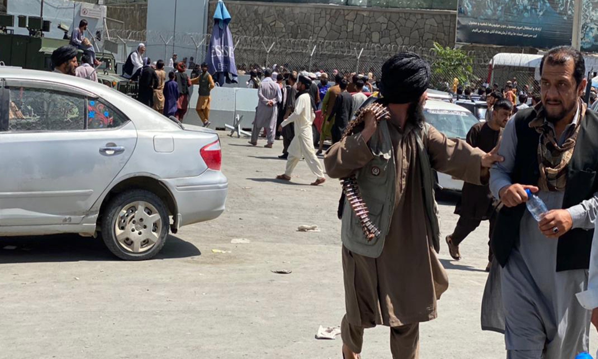 People gather outside the Hamid Karzai International Airport, to flee Afghanistan on Monday. Photo: IC