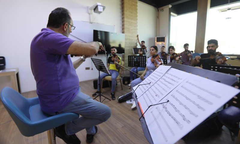 Orchestra members join to rehearse symphonic music in Mosul, Iraq on July 3, 2021.(Photo: Xinhua)