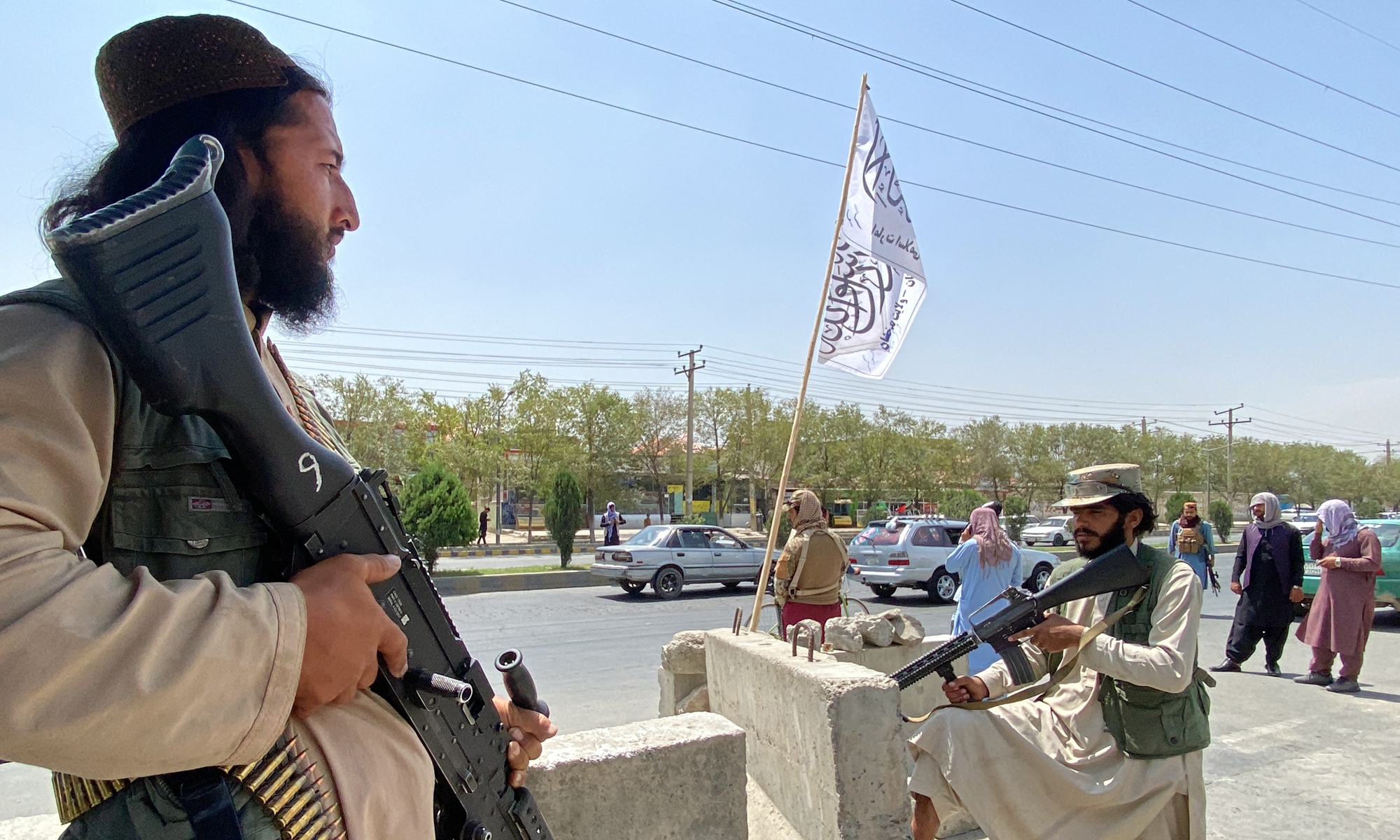Taliban fighters stand guard at an entrance gate outside the Interior Ministry in Kabul on Tuesday. Photo: AFP