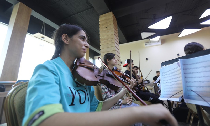 Orchestra members join to rehearse symphonic music in Mosul, Iraq on July 3, 2021.(Photo: Xinhua)