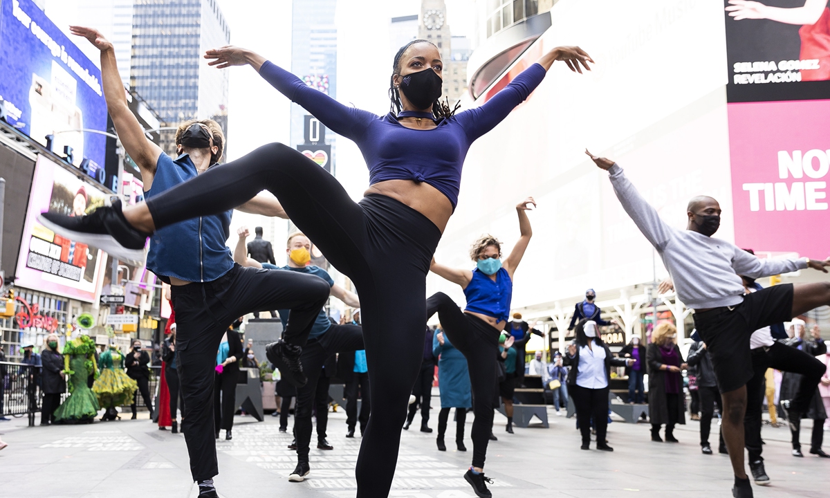 Broadway dancers and actors perform during a pop-up performance in Times Square to commemorate a year since theaters on Broadway were shut down due to the coronavirus pandemic in New York on March 12. Photos: AFP  