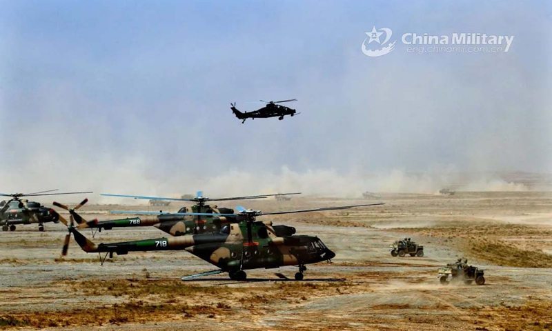 The assault vehicles Lynx rush out from the landed military helicopters to conduct coordinated operations in the China-Russia joint military exercise ZAPAD/INTERACTION-2021 at a training base of the PLA Army in Qingtongxia City of West China's Ningxia Hui Autonomous Region from August 9 to 13, 2021. (eng.chinamil.com.cn/Photo by Wang Weidong)