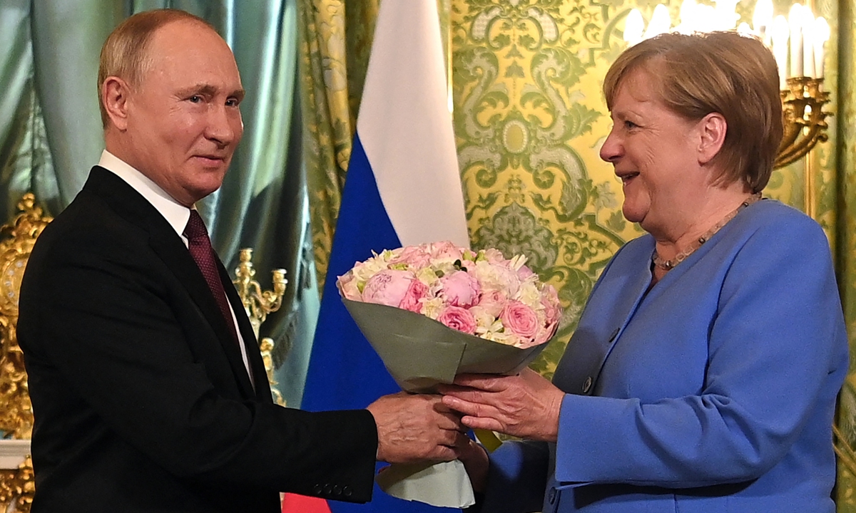 Russian President Vladimir Putin (left) welcomes German Chancellor Angela Merkel with a bouquet of flowers during their meeting in Moscow on Friday. The trip will be the 20th and last visit to Russia for Merkel as German Chancellor, who will bow out of politics following an election in Germany on September 26. Photo: AFP