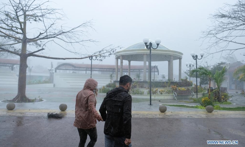 People walk in the rain caused by the landfall of Hurricane Grace in Puerto Morelos, Quintana Roo, Mexico, on Aug. 19, 2021.Photo:Xinhua