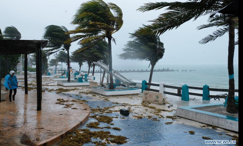 A person walks in the rain caused by the landfall of Hurricane Grace in Puerto Morelos, Quintana Roo, Mexico, on Aug. 19, 2021.Photo:Xinhua