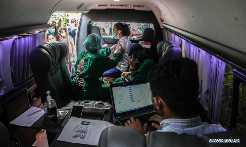 A woman receives a dose of COVID-19 vaccine at a mobile vaccination site in Medan, North Sumatra, Indonesia, Aug. 19, 2021.Photo:Xinhua