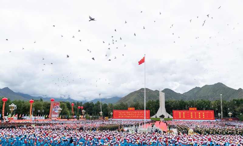 Pigeons fly over the sky during a grand gathering to celebrate the 70th anniversary of the peaceful liberation of Tibet at the Potala Palace square in Lhasa, southwest China's Tibet Autonomous Region, Aug. 19, 2021. More than 20,000 people from various ethnic groups attended the event held in Lhasa. Photo:Xinhua