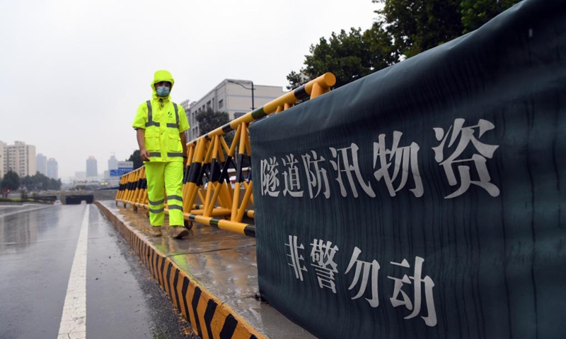 A staff member works at the entrance of a tunnel in Zhengzhou, capital of central China's Henan Province, Aug. 22, 2021. Photo: Xinhua
