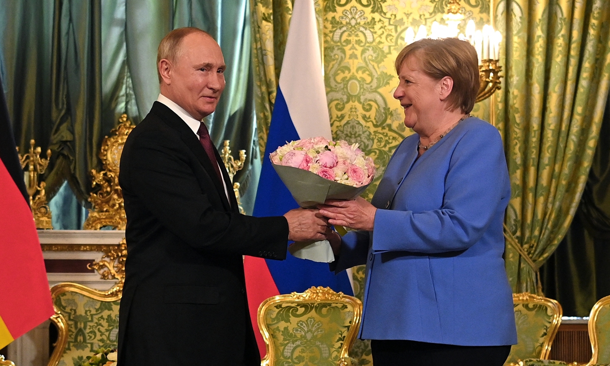 Russian President Vladimir Putin (left) welcomes German Chancellor Angela Merkel during their meeting at the Kremlin in Moscow, on Friday. Photo: AFP