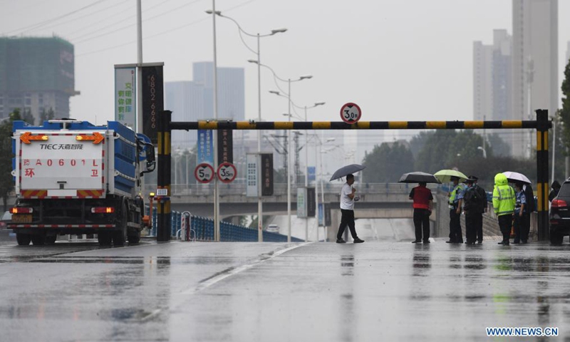 Staff members are on duty near a railway culvert in Zhengzhou, capital of central China's Henan Province, Aug. 22, 2021. Photo: Xinhua