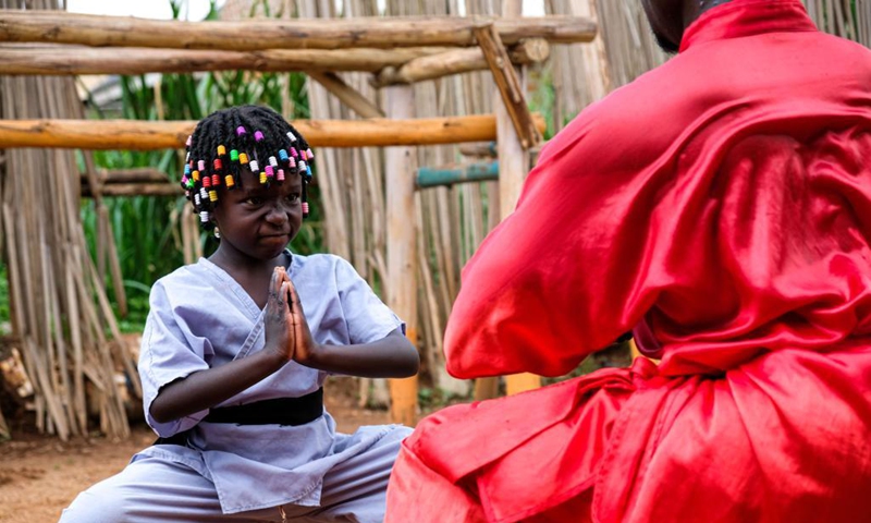 Manisuru Ssejjemba stretches during his Chinese martial arts training at a makeshift training center behind his house in Katooke, north of Uganda's capital Kampala, Aug. 17, 2021.Photo: Xinhua