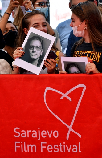 Billboards show posters for the 27th Sarajevo Film Festival in Sarajevo on August 15. 
Right: Fans wait for the arrival of Irish rock legend, Bono Vox on the red carpet during the 27th Sarajevo Film Festival, in front of the Bosnian National Theatre on August 15. Australian director Sebastian Meise receives the Best Feature Film award for Great Freedom in Sarajevo on Thursday. Photos: AFP  