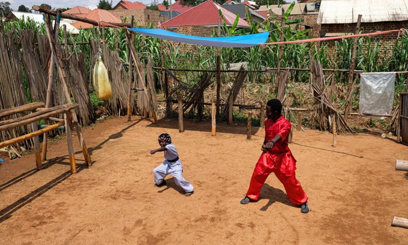 Manisuru Ssejjemba stretches during his Chinese martial arts training at a makeshift training center behind his house in Katooke, north of Uganda's capital Kampala, Aug. 17, 2021.Photo: Xinhua