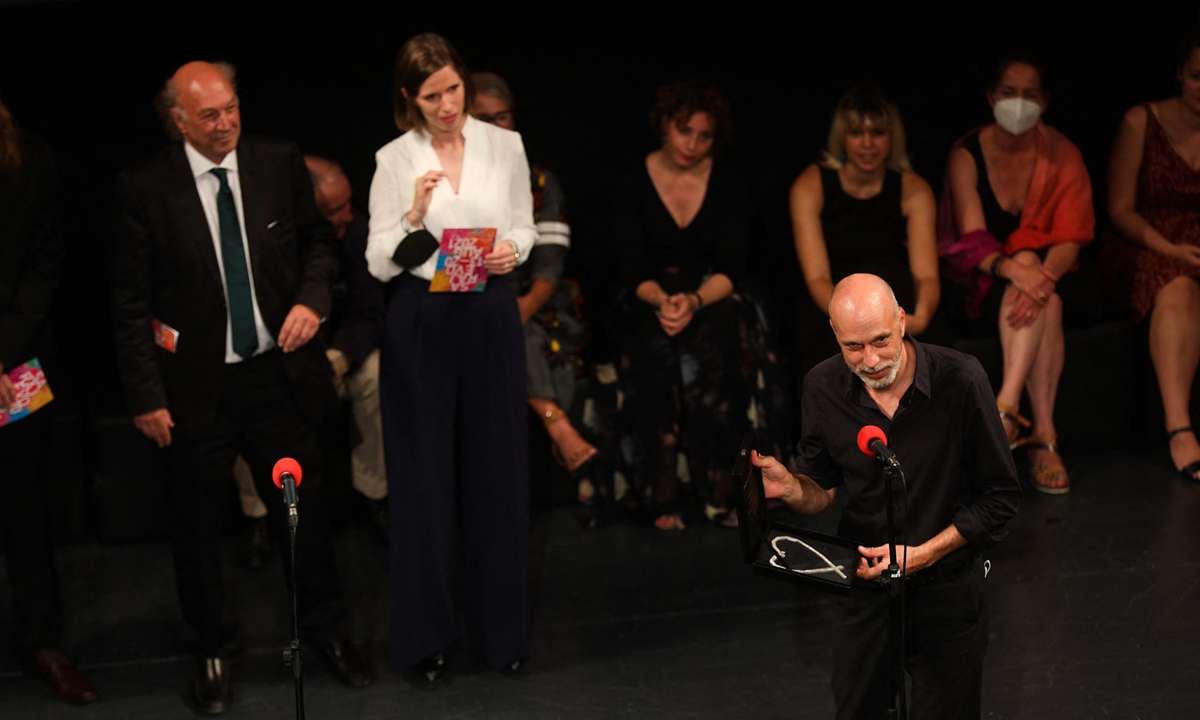 Billboards show posters for the 27th Sarajevo Film Festival in Sarajevo on August 15. 
Right: Fans wait for the arrival of Irish rock legend, Bono Vox on the red carpet during the 27th Sarajevo Film Festival, in front of the Bosnian National Theatre on August 15. Australian director Sebastian Meise receives the Best Feature Film award for Great Freedom in Sarajevo on Thursday. Photos: AFP  