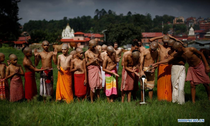 Nepalese students from a Hindu priest school perform a ritual during Janai Purnima Festival celebrations on the premises of Pashupatinath temple in Kathmandu, Nepal on Aug. 22, 2021.(Photo: Xinhua)