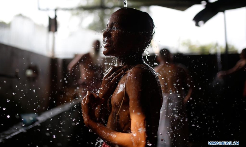 A student from a Hindu priest school performs a ritual during Janai Purnima Festival celebrations on the premises of Pashupatinath temple in Kathmandu, Nepal on Aug. 22, 2021.(Photo: Xinhua)