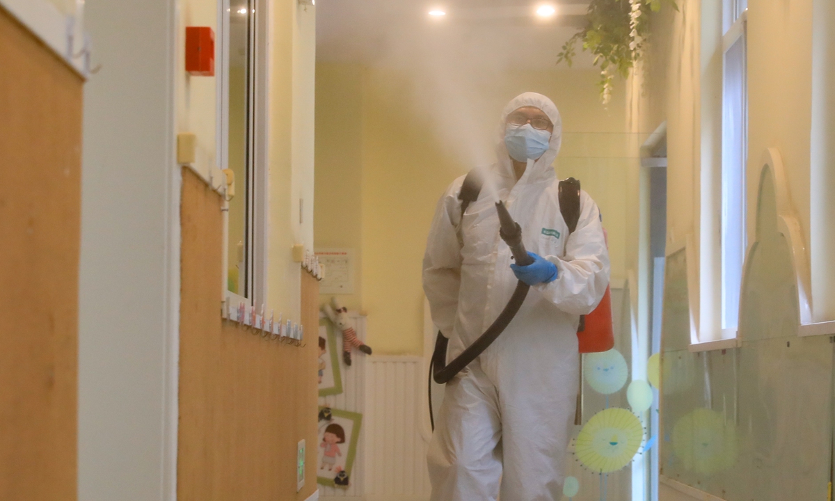A staff member of a kindergarten in Hefei, capital of East China's Anhui Province, disinfects the facility on Monday, a week ahead of the beginning of the new semester. According to local COVID-19 epidemic control and prevention rules for education systems, supplies including face masks, disinfectant and infrared sensor thermometers must be in place before schools open. 
Photo: cnsphoto