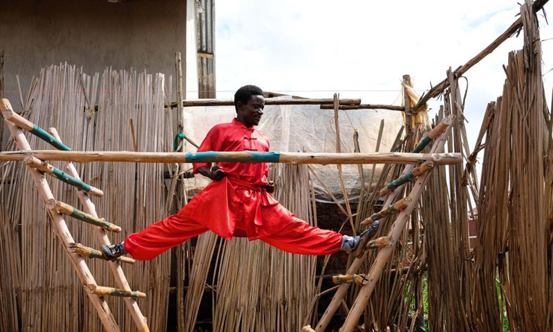 Manisuru Ssejjemba stretches during his Chinese martial arts training at a makeshift training center behind his house in Katooke, north of Uganda's capital Kampala, Aug. 17, 2021.Photo: Xinhua