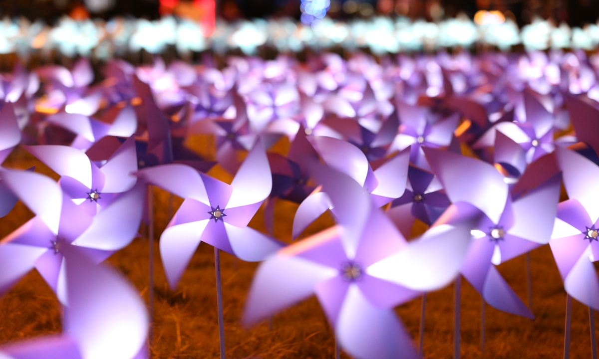 Nearly 14,000 lightened windmills form a sea of light, turning with the wind, lighting up the night of Shanghai. Photo: IC