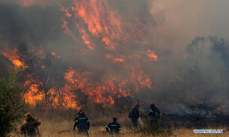 Firefighters battle a blaze in Vilia to the northwest of Athens, Greece, on Aug. 23, 2021. A new wildfire broke out here on Monday, burning in thick forest land.(Photo: Xinhua)