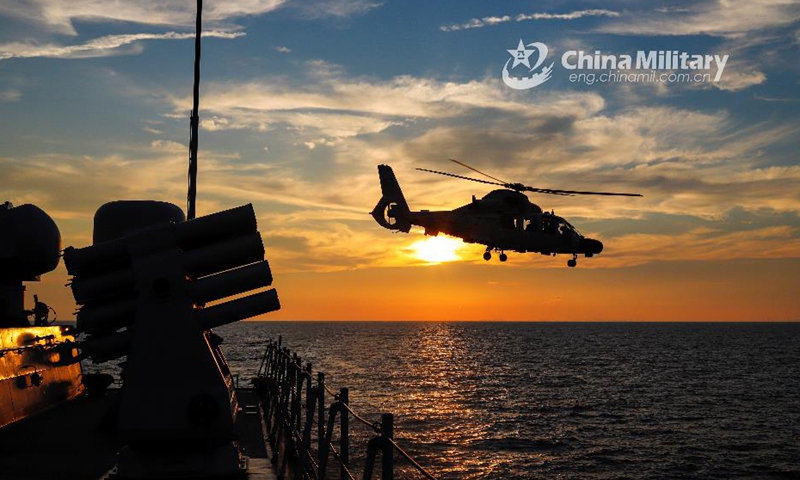 A ship-borne helicopter attached to a destroyer flotilla with the navy under the PLA Northern Theater Command practices lifting off and landing on the flight deck of the guided-missile frigate Anqing during a maritime training exercise in late July, 2021. (eng.chinamil.com.cn/Photo by Ma Yubin)