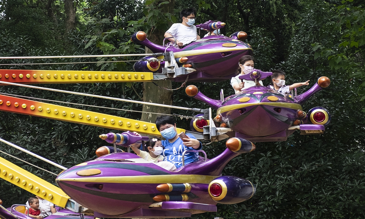 After a brief COVID-19 backlash, a playground in Wuhan, Central China's Hubei Province, resumed operations on Saturday. Children and parents took advantage of the last part of their summer vacation to go and relax, all wearing masks. Photo: IC