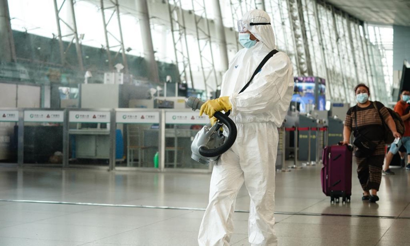A staff member disinfects at Nanjing Railway Station in Nanjing, capital of east China's Jiangsu Province, Aug. 23, 2021. Nanjing, which witnessed the country's latest resurgence of coronavirus cluster infections attributable to the Delta variant, cleared all medium- and high-risk areas for COVID-19 on Aug. 19. From Aug. 23, people leaving Nanjing by rail, highway, waterway, etc. will no longer be required to provide negative nucleic acid test certificates. (Xinhua/Ji Chunpeng)