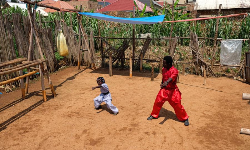 Hasifa Nakirijja (L) and her father Manisuru Ssejjemba practice Chinese martial arts at a makeshift training center behind their house in Katooke, north of Uganda's capital Kampala, Aug. 17, 2021.(Photo: Xinhua)