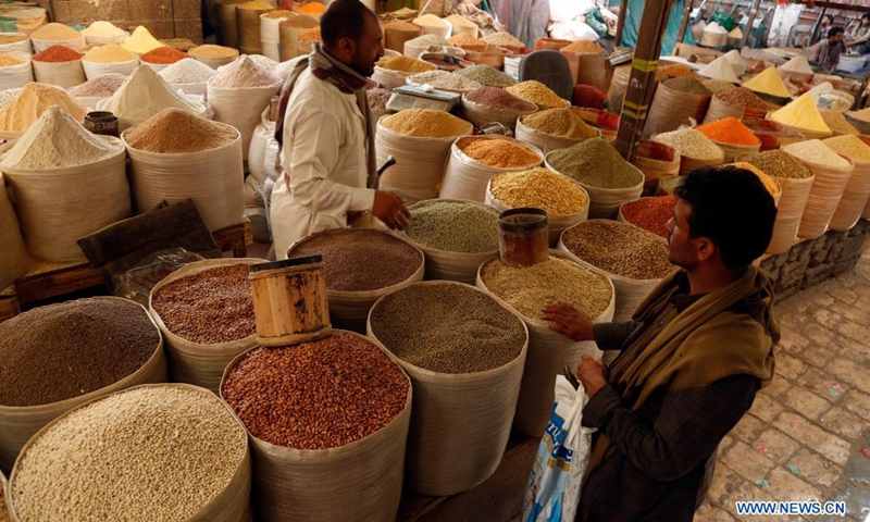 Yemenis buy grains on a market in Sanaa, Yemen on Aug. 24, 2021. More than half of Yemenis are facing crisis levels of food insecurity, and 5 million people are one step away from famine. As the value of the Yemeni rial continues to plummet, more and more Yemenis are being pushed to the brink.(Photo: Xinhua)