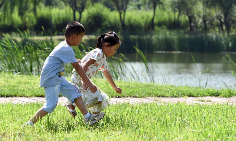 Children play at Xinghuagou wetland park transformed from the mining subsidence area of Jingxing in Shijiazhuang, north China's Hebei Province, Aug. 24, 2021.Photo: Xinhua