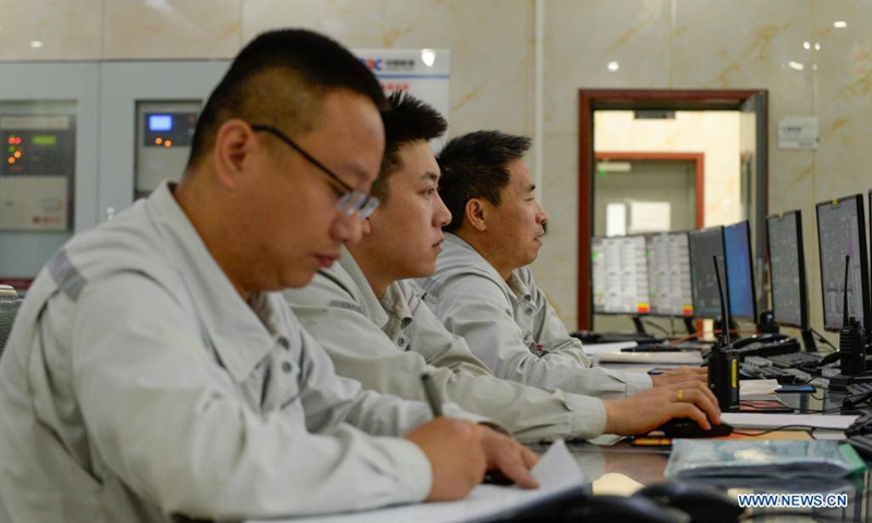 Staff members work at the control room of a photothermal power station in Hami, northwest China's Xinjiang Uygur Autonomous Region, Aug. 22, 2021. The photothermal power station is the first of its kind in Xinjiang. The project is a modern attempt by the region to capitalize on its abundant solar energy and turn it into heat and power. (Xinhua/Gao Han)