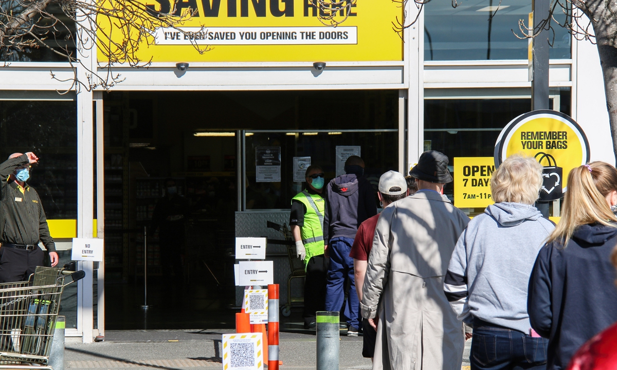 Shoppers stand in line at a Christchurch supermarket on Wednesday. Sixty-three new COVID-19 cases were confirmed in New Zealand, bringing the total to 21,012. The country is vaccinating nationals faster amid epidemic with record 80,000 doses administered on Tuesday. Photo: VCG