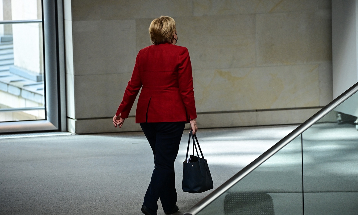 German Chancellor Angela Merkel leaves the plenary session in the German lower house of parliament Bundestag in Berlin, Germany on Wednesday. Photo: AFP