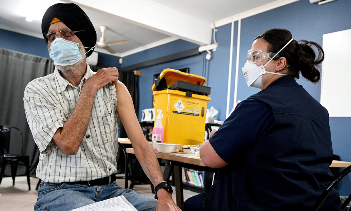 A man from a Sikh community gets ready to receive his first dose of Pfizer vaccine inside a temple in the suburb of Glenwood in Sydney, Australia on Thursday, as more than 1,000 new local coronavirus cases were reported for the first time during the pandemic. Photo: AFP