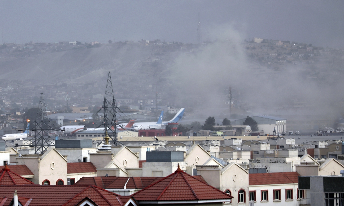 Smoke rises from Hamid Karzai International Airport in Kabul, Afghanistan on Thursday after an explosion as thousands of people try to leave the country. There was no official count of casualties as of press time but a witness claimed several appeared to have been killed or wounded. Photo: AP