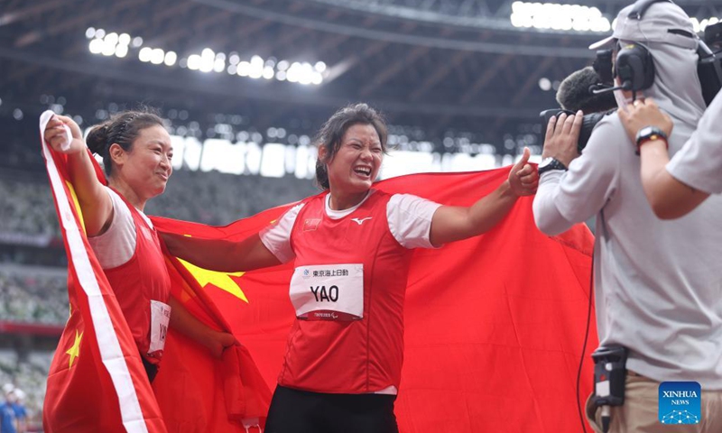 Yao Juan (C) and Yang Yue (L) of China celebrate after the women's F64 class discus throw final at the Tokyo 2020 Paralympic Games in Tokyo, Japan, Aug. 29, 2021. (Xinhua/Du Xiaoyi)